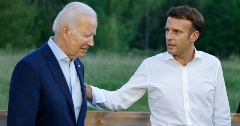 President Joe Biden, left, and French President Emmanuel Macron, right, talk after taking a group photo during the G7 Summit at Elmau Castle in Germany on Sunday.