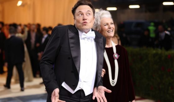 Elon Musk, seen at the May 2 Met Gala in New York City with his mother, Maye Musk, has some grim predictions for the economy - and for remote workers.