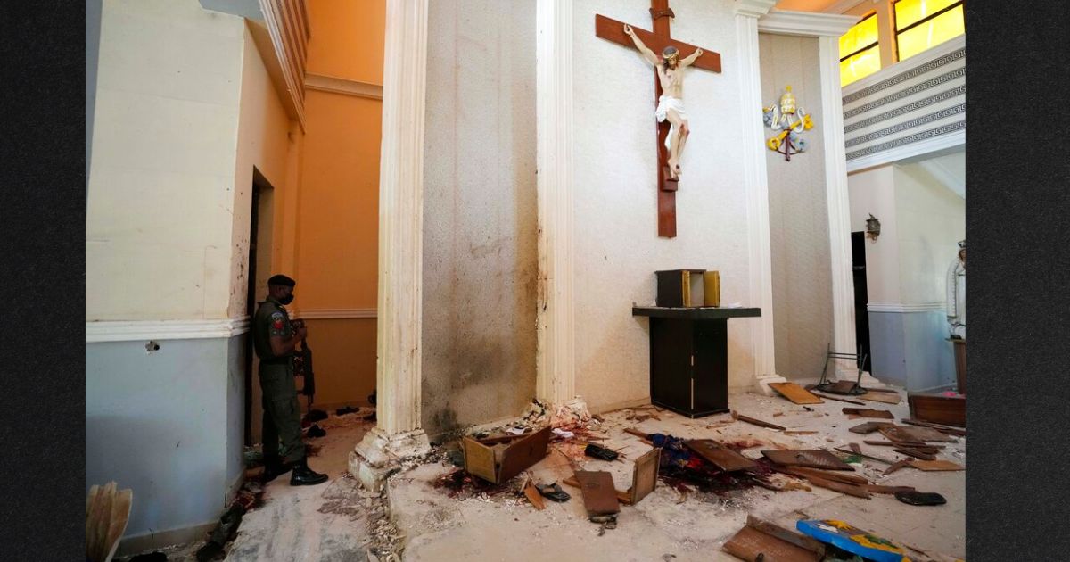 A police officer stands guard inside the St. Francis Catholic Church, on Monday, a day after an attack that targeted worshipers in Owo, Nigeria. The gunmen who killed 50 people at a Catholic church in southwestern Nigeria opened fire on worshippers both inside and outside the building in a coordinated attack before escaping the scene, authorities and witnesses said Monday.
