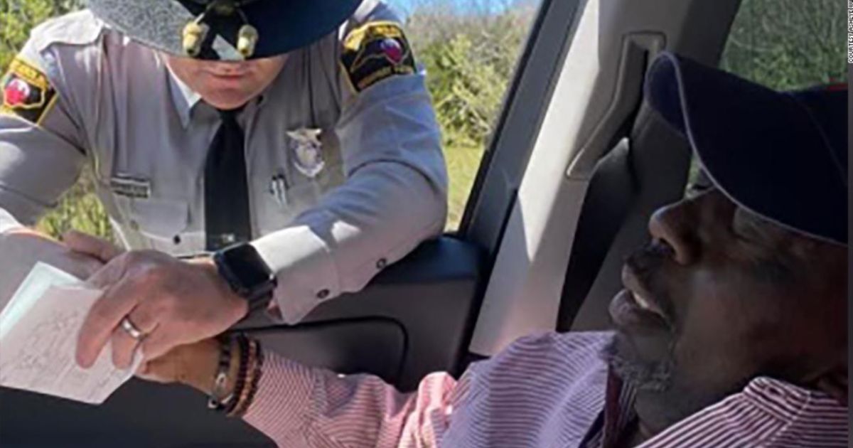 North Carolina State Highway Patrol Trooper Jaret Doty, left, asked if he could pray with Anthony Geddis, right, after pulling his daughter, Ashlye Wilkerson, over for speeding on their way back from Geddis' chemotherapy treatment.