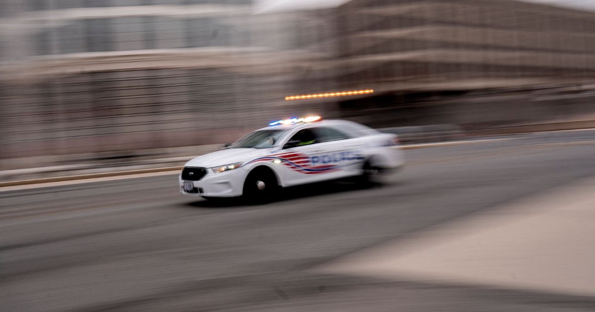 A police car is pictured driving through Washington, D.C., on Jan. 25.