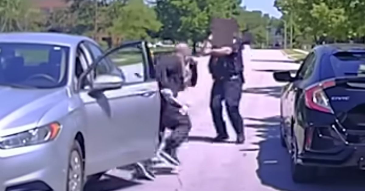 Footage from the police officer's dash camera shows the oncoming car stopping just a few feet from the officer. The driver jumps out and charges the officer with a hatchet in his hand.