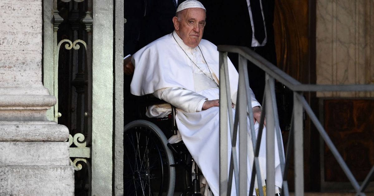 Pope Francis, who has been wheelchair-bound for several weeks, leaves the Basilica of St. Mary Major in Rome after presiding over the Rosary for peace in Ukraine on Tuesday.