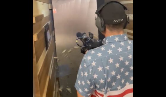 Kyle Rittenhouse fires an automatic gun at a range.