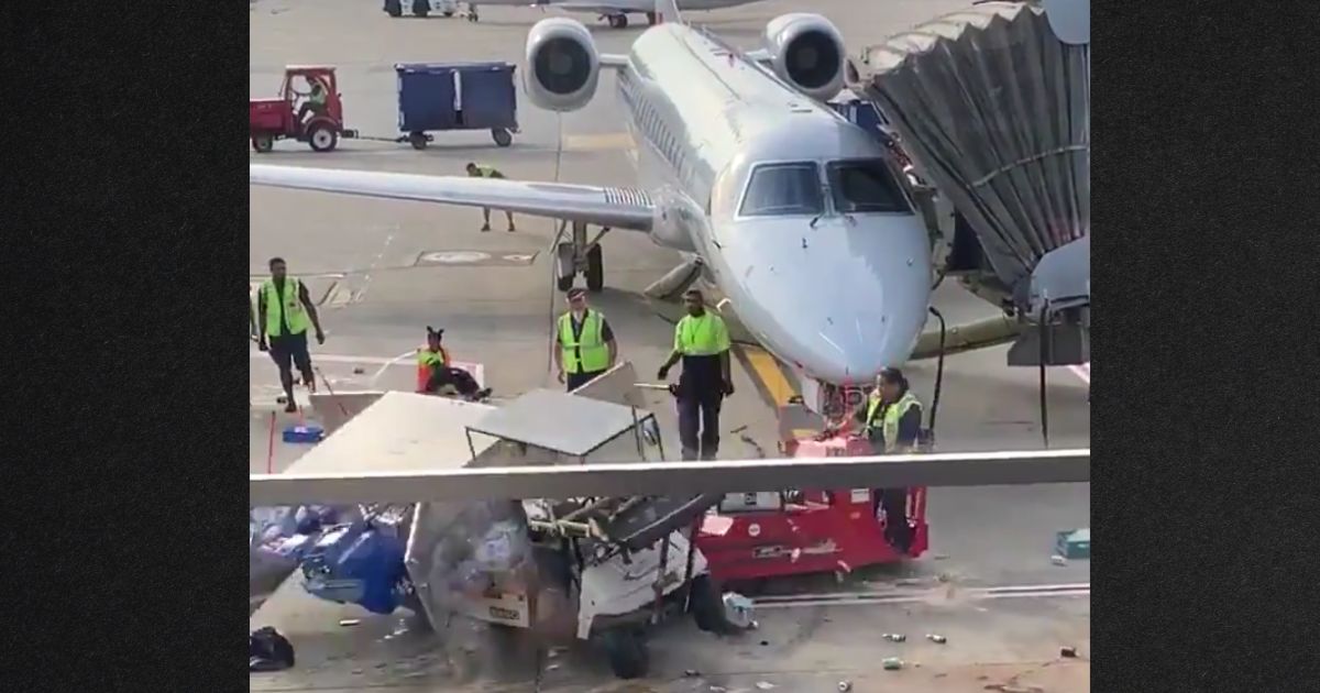 An airport worker (at right, riding red tug) rammed the runaway cart to keep it from hitting the jet.