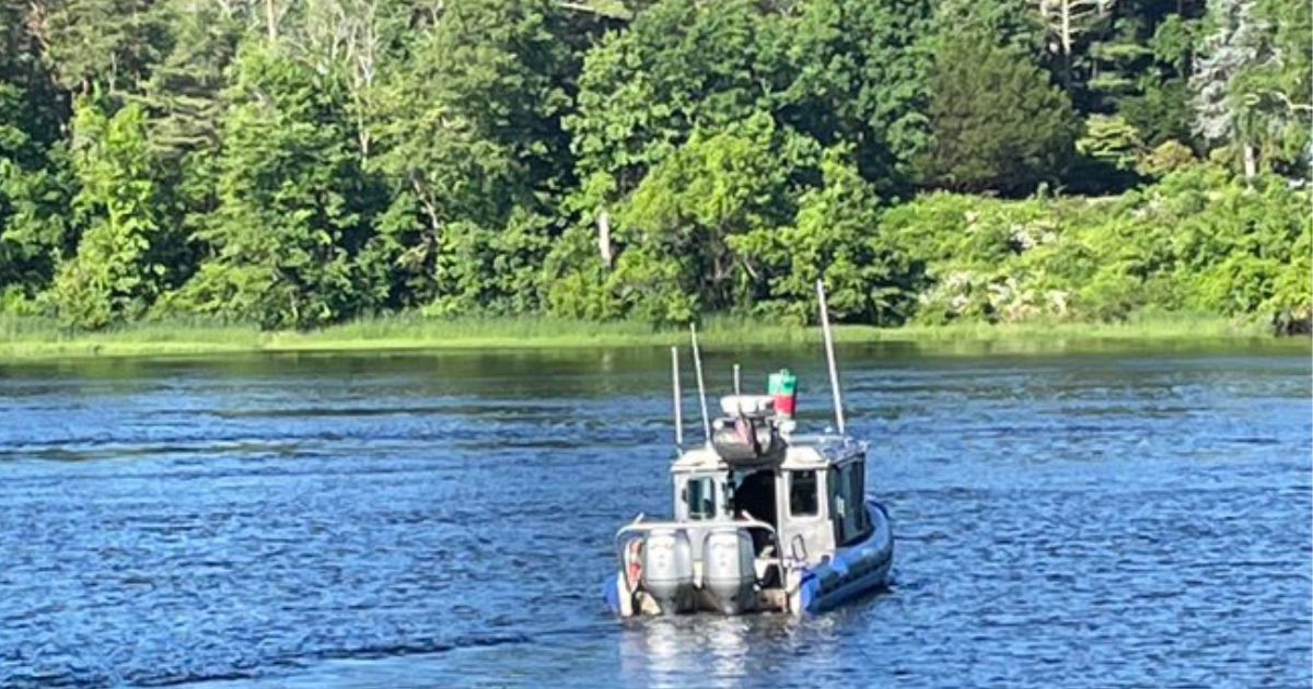 Rescuers search for a boy in the Merrimack River on Friday.