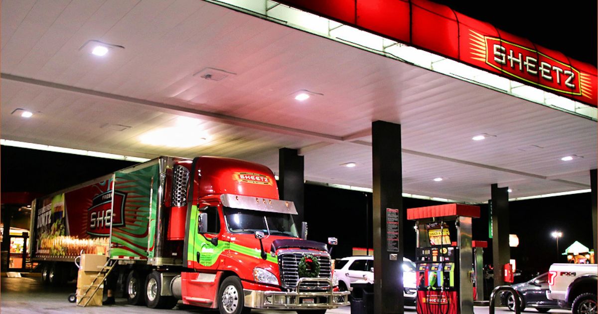 While several customers fill up on gas, a Sheetz 2017 Freightliner Trucks Cascadia makes a delivery to restock a Sheetz store.