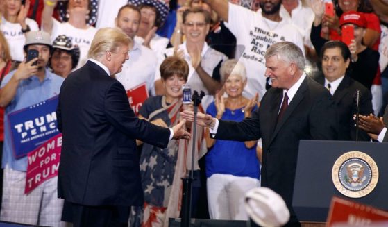 Former U.S. President Donald Trump and Franklin Graham greet at the Trump rally in Phoenix, on Aug. 22.