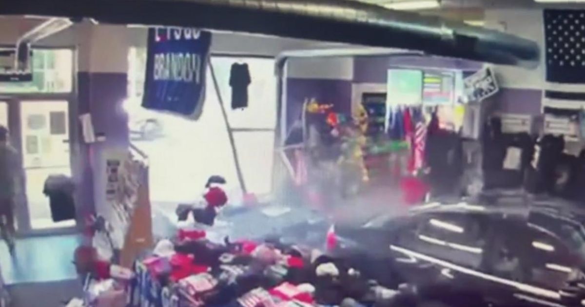 A car crashes into a Trump merchandise store in South Easton, Mass., on Thursday.
