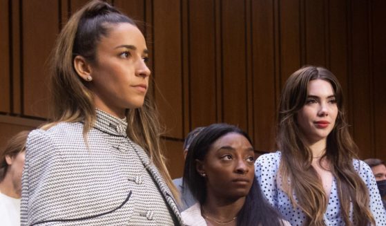 U.S. Olympic gymnasts, from left to right, Aly Raisman, Simone Biles, and McKayla Maroney prepare to leave after giving testimony at a Senate Judiciary hearing concerning the FBI handling of the Larry Nassar investigation of sexual abuse of U.S. gymnasts on Sept. 15, 2021.
