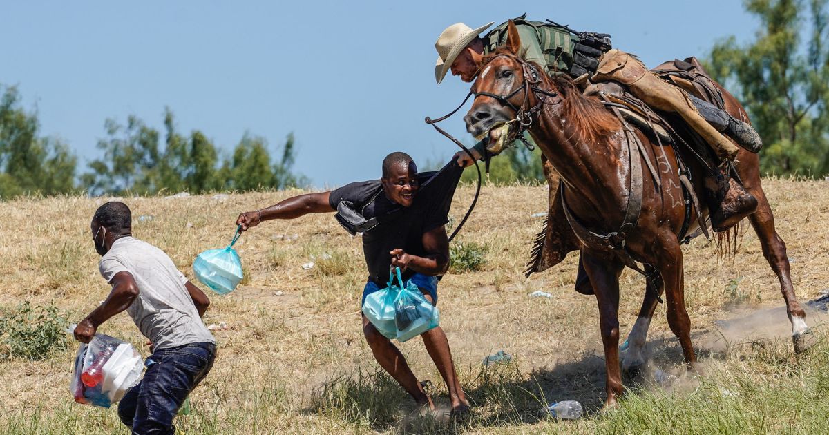 A Border Patrol agent on horseback pursues a Haitian immigrant in a September file photo.
