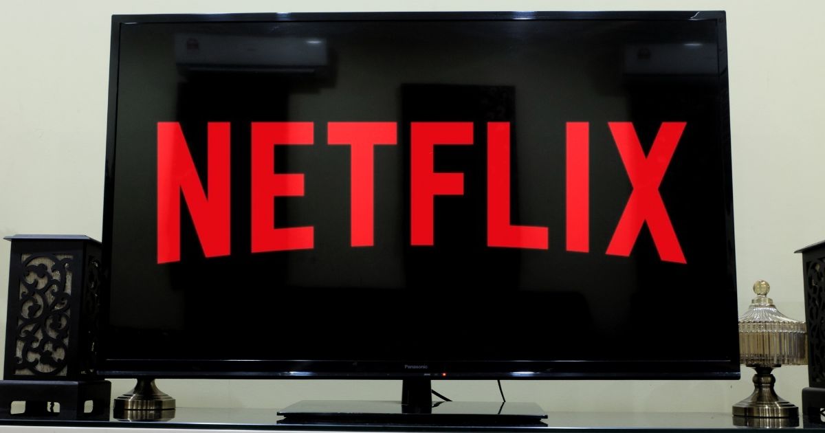 The Netflix logo is shown on a television screen.