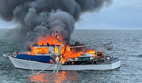 A commercial fishing boat burns about two miles west of Manzanita Beach in Oregon on Saturday. The lone fisherman aboard was rescued by a fellow angler before the boat was consumed by flames. The fisherman whose boat caught on fire had "no medical concerns," according to the U.S. Coast Guard.