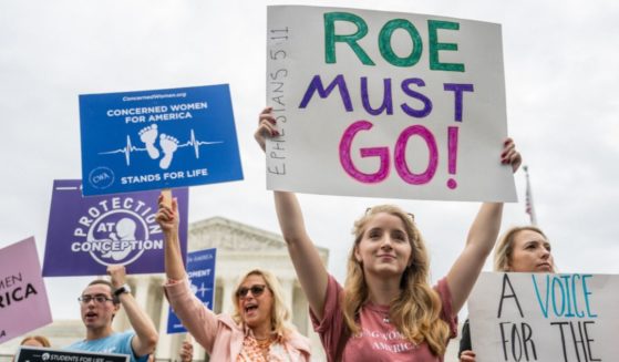 Pro-life activists demonstrate outside the front of the Supreme Court ruling on Tuesday.
