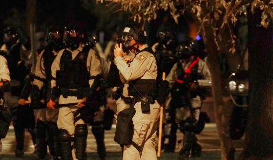Riot police surround the Arizona Capitol after protesters reached the front of the Arizona Senate building in Phoenix after the release of the Supreme Court's decision to overturn Roe v. Wade on Friday.