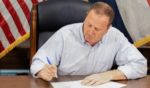 Missouri Attorney General Eric Schmitt signs a law banning abortion in the state of Missouri on Friday.