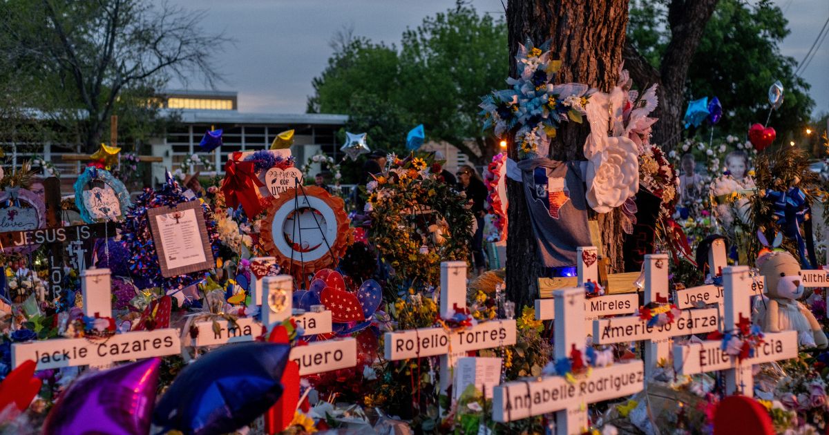 Gifts and makeshift crosses are seen Tuesday at a memorial dedicated to the 19 children and two adults killed on May 24 during the mass shooting at Robb Elementary School in Uvalde, Texas.