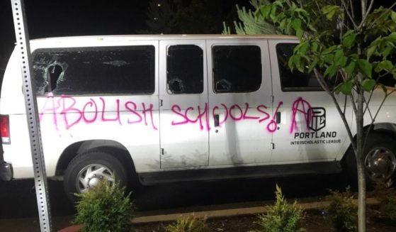 Windows were broken and "Abolish schools" was painted on the side of a Portland Interscholastic League van during rioting over the weekend.