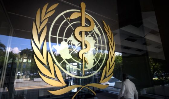 The logo of the World Health Organization is seen at the entrance of the agency's headquarters on May 18, 2018, in Geneva.