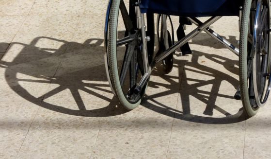 A wheelchair and its shadow are pictured.