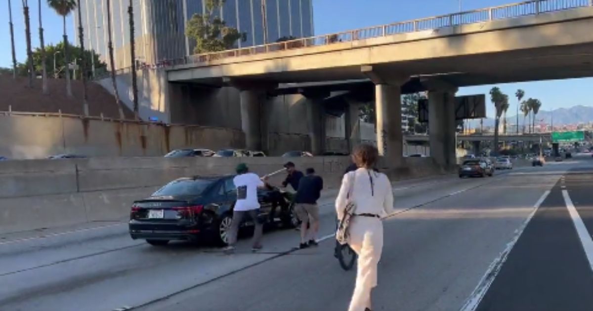 Pro-abortion demonstrators attack a driver on a freeway in Los Angeles on Friday.