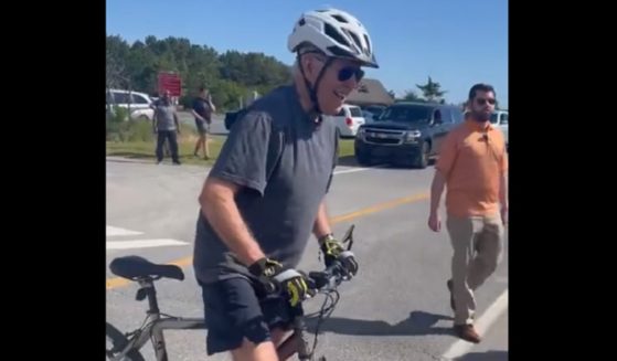 President Joe Biden stops on his bike in Delaware on Satureday before taking a fall that was capture on camera.
