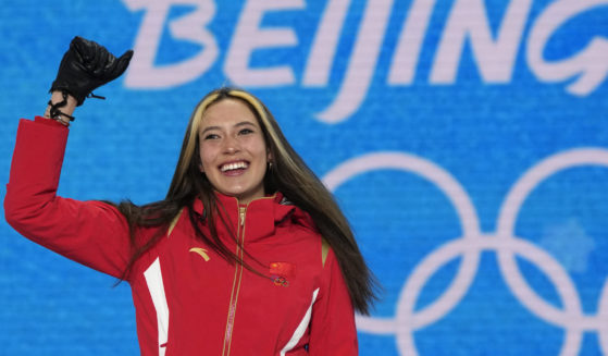 Gold medalist Eileen Gu celebrates during a medal ceremony for the women's freestyle skiing halfpipe competition at the 2022 Winter Olympics on Feb. 18 in Zhangjiakou, China.