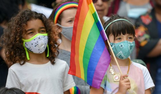 A child holding an LGBT flag watches a performance on June 13, 2021, in the Brooklyn borough of New York City.