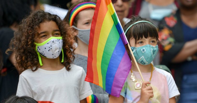 A child holding an LGBT flag watches a performance on June 13, 2021, in the Brooklyn borough of New York City.