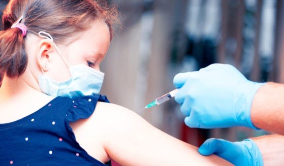 A child receives a vaccination in this stock image.