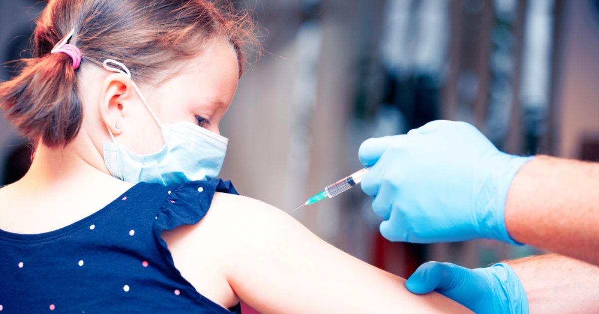 A child receives a vaccination in this stock image.