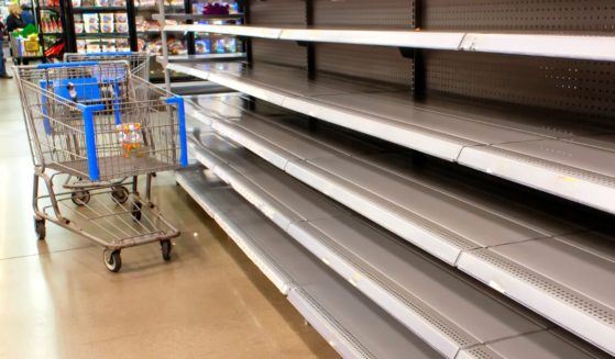 Empty grocery store shelves are seen in the above stock image.