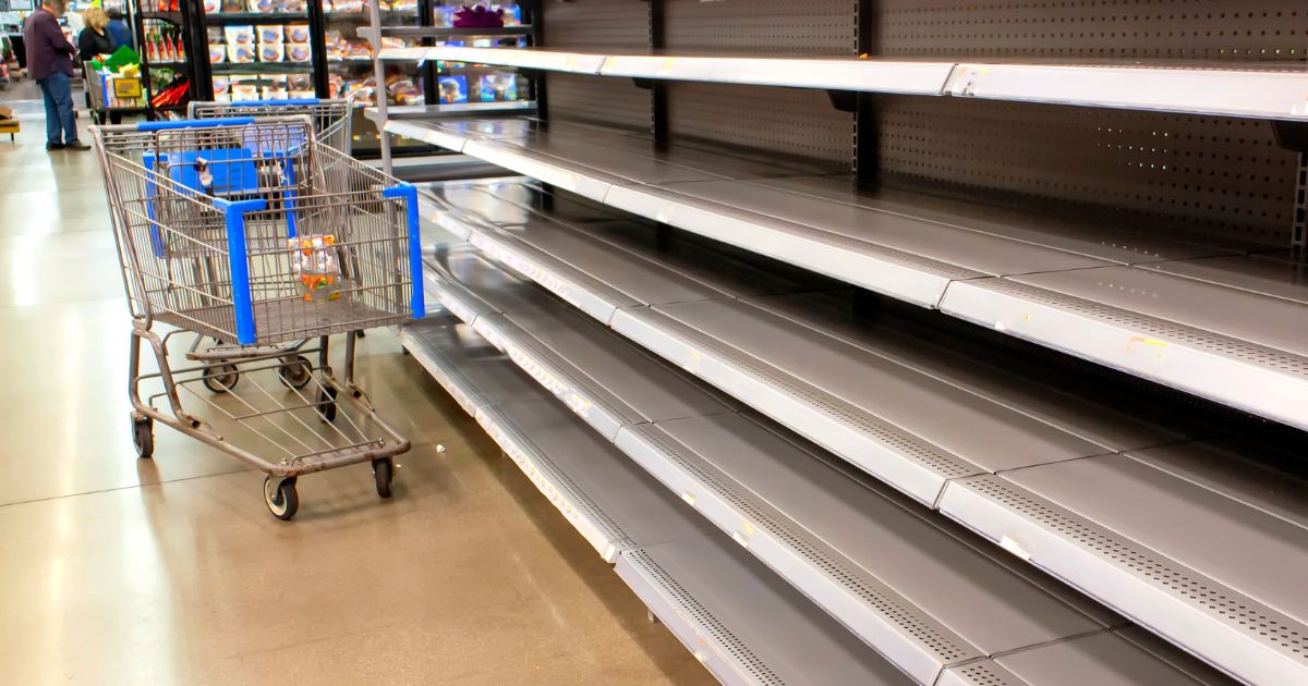 Empty grocery store shelves are seen in the above stock image.