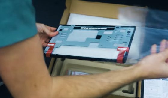 A digital license plate being installed.