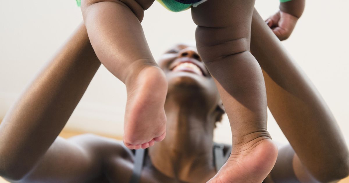 A mother plays with her baby in this stock image.