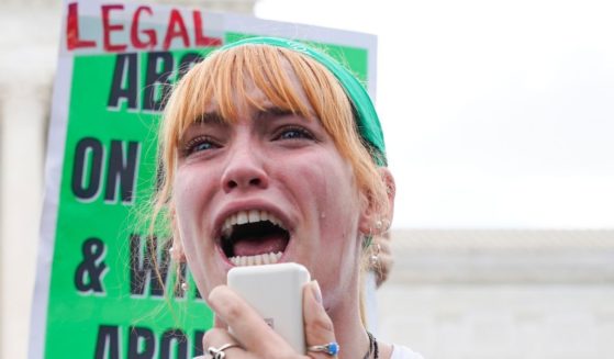 A pro-abortion activist speaks while crying
