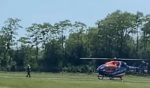 An emergency helicopter lands near the site of a skydiving accident Sunday in Yorkville, Wisconsin.