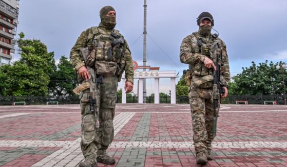 Russian servicemen patrol a square in central Melitopol, Ukraine, on Tuesday.