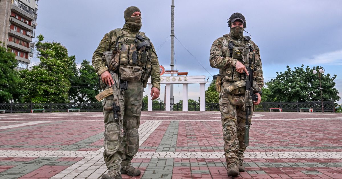 Russian servicemen patrol a square in central Melitopol, Ukraine, on Tuesday.