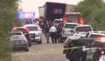 Police and medical personell swarm around a tractor-trailer that was found in San Antonio, Texas, on Monday packed with at least 46 bodies of illegal immigrants. Sixteen others were taken to a hospital.