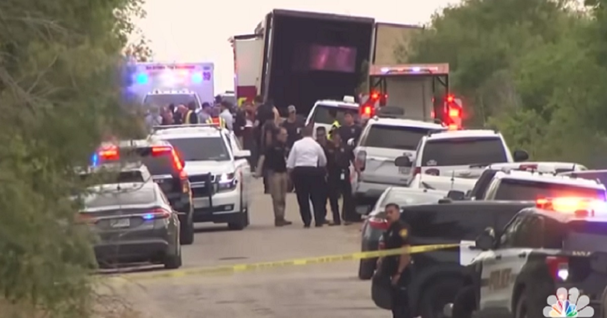 Police and medical personell swarm around a tractor-trailer that was found in San Antonio, Texas, on Monday packed with at least 46 bodies of illegal immigrants. Sixteen others were taken to a hospital.