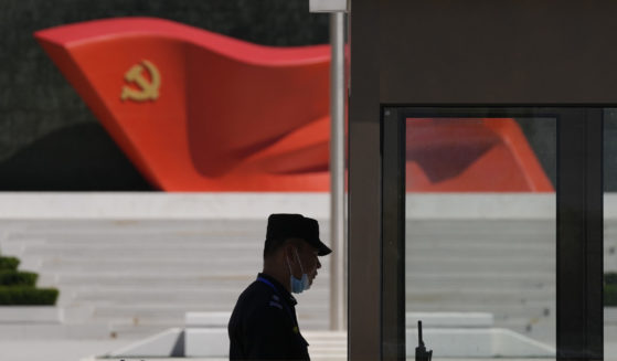 A security guard stands near a sculpture of the Chinese Communist Party flag at the Museum of the Communist Party of China on May 26 in Beijing.