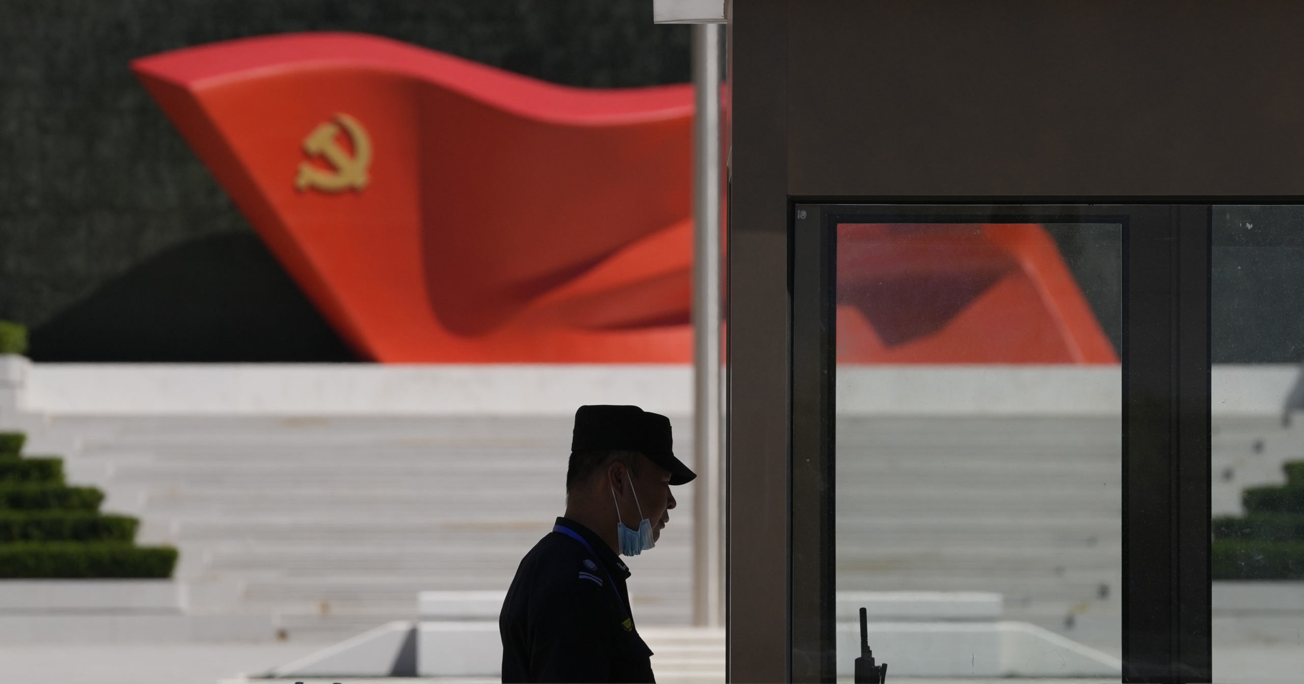 A security guard stands near a sculpture of the Chinese Communist Party flag at the Museum of the Communist Party of China on May 26 in Beijing.
