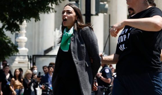 Democratic Rep. Alexandria Ocasio-Cortez of New York is detained by U.S. Capitol Police after participating in a pro-abortion protest in front of the U.S. Supreme Court Building in Washington on Tuesday.