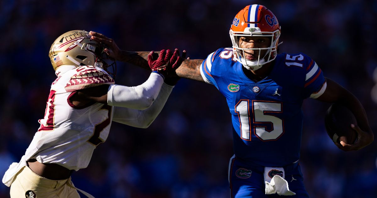 Florida quarterback Anthony Richardson stiff-arms Kalen DeLoach of the Florida State Seminoles during the Gators' 24-21 victory at Ben Hill Griffin Stadium in Gainesville on Nov. 27.
