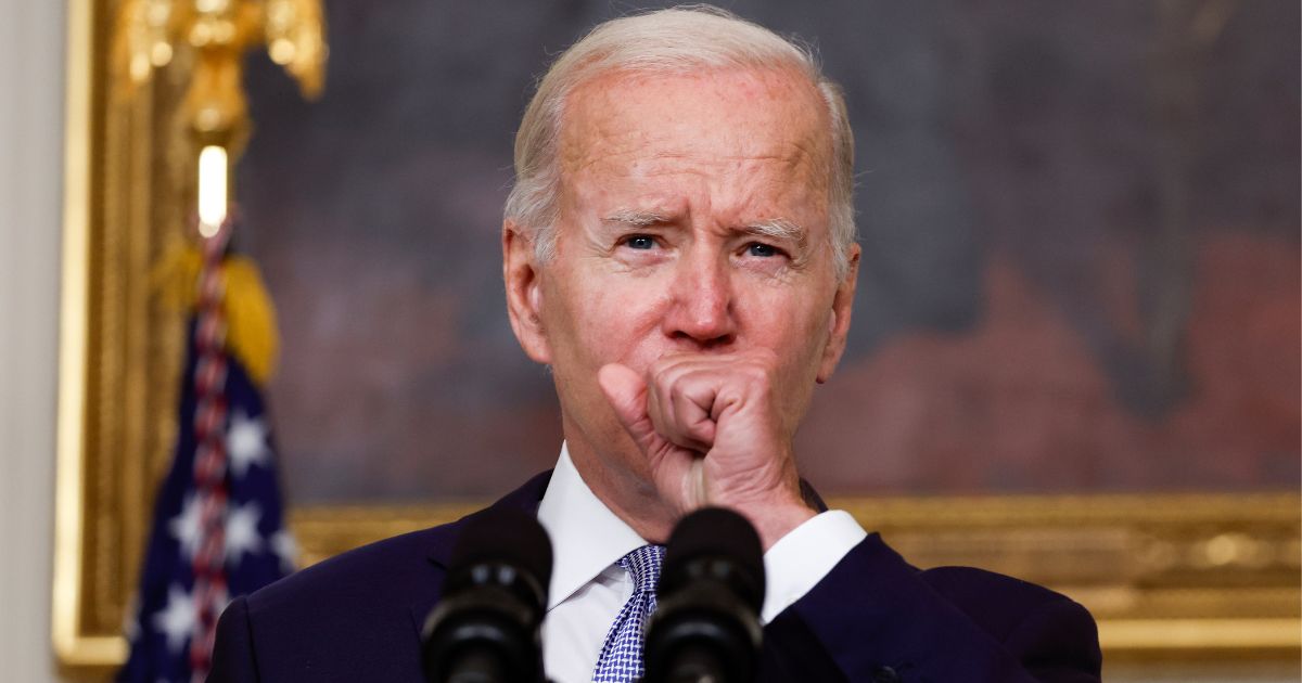 President Joe Biden coughs as he delivers remarks on the Inflation Reduction Act of 2022 Thursday at the White House. Biden tested positive again for COVID, after several days of testing negative.