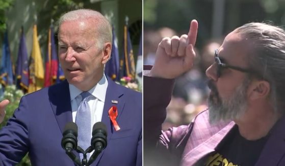 During a speech on Monday morning discussing gun violence and gun legislation, President Joe Biden, left, was interrupted by a protester, right.