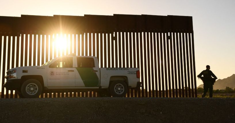 A Border Patrol agent walks along the border wall between the U.S. and Mexico in Yuma, Arizona, on June 1.