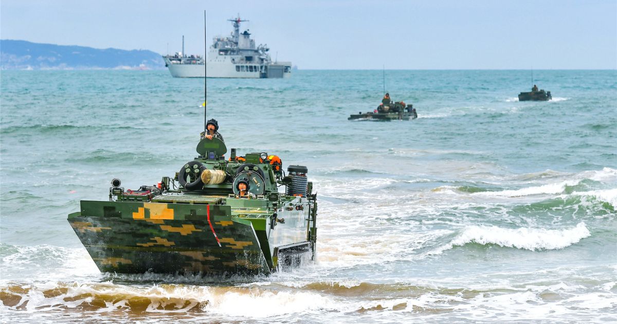Riding on a People's Liberation Army amphibious infantry fighting vehicle, Chinese soldiers participate in a ferrying and assault wave formation training exercise on May 7.