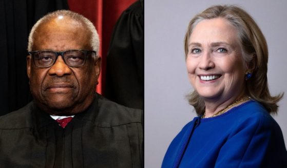 Justice Clarence Thomas, left, sits for a group photo of the Supreme Court justices in Washington, D.C., on April 23, 2021. Hillary Clinton poses during a photo session in Paris on June 10.